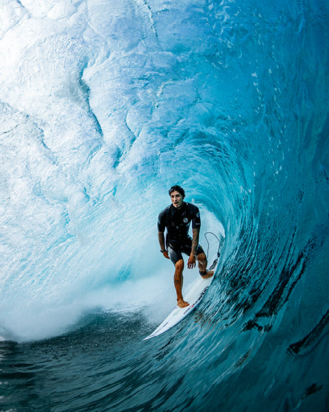 Surfer riding a large wave in the ocean