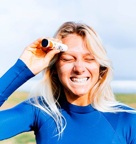 Woman applying sunscreen