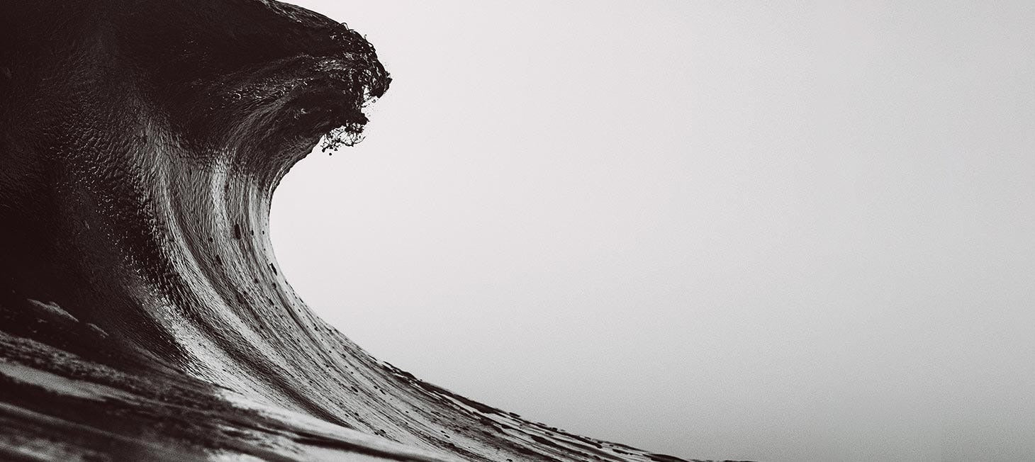 Black and white wave crashing against a light gray background