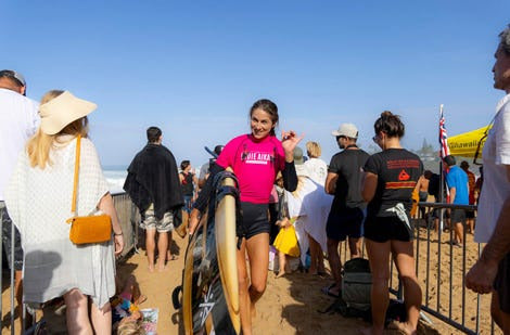 Surfer running through the crowd 