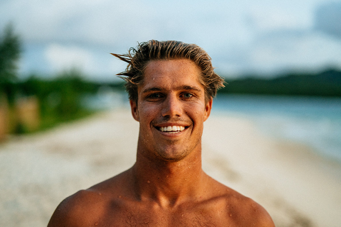 A smiling man with wet skin