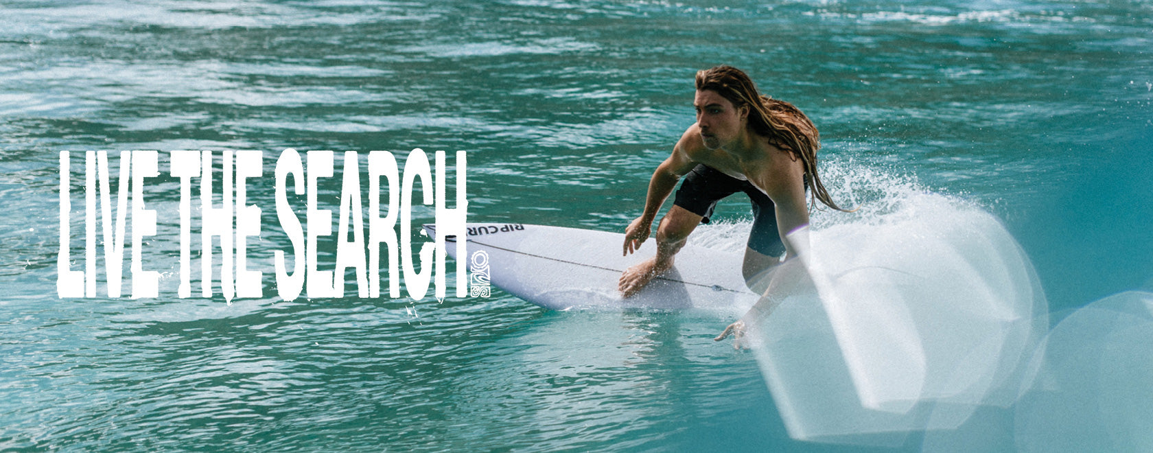 Person surfing on a wave with 'Live the Search' text overlay