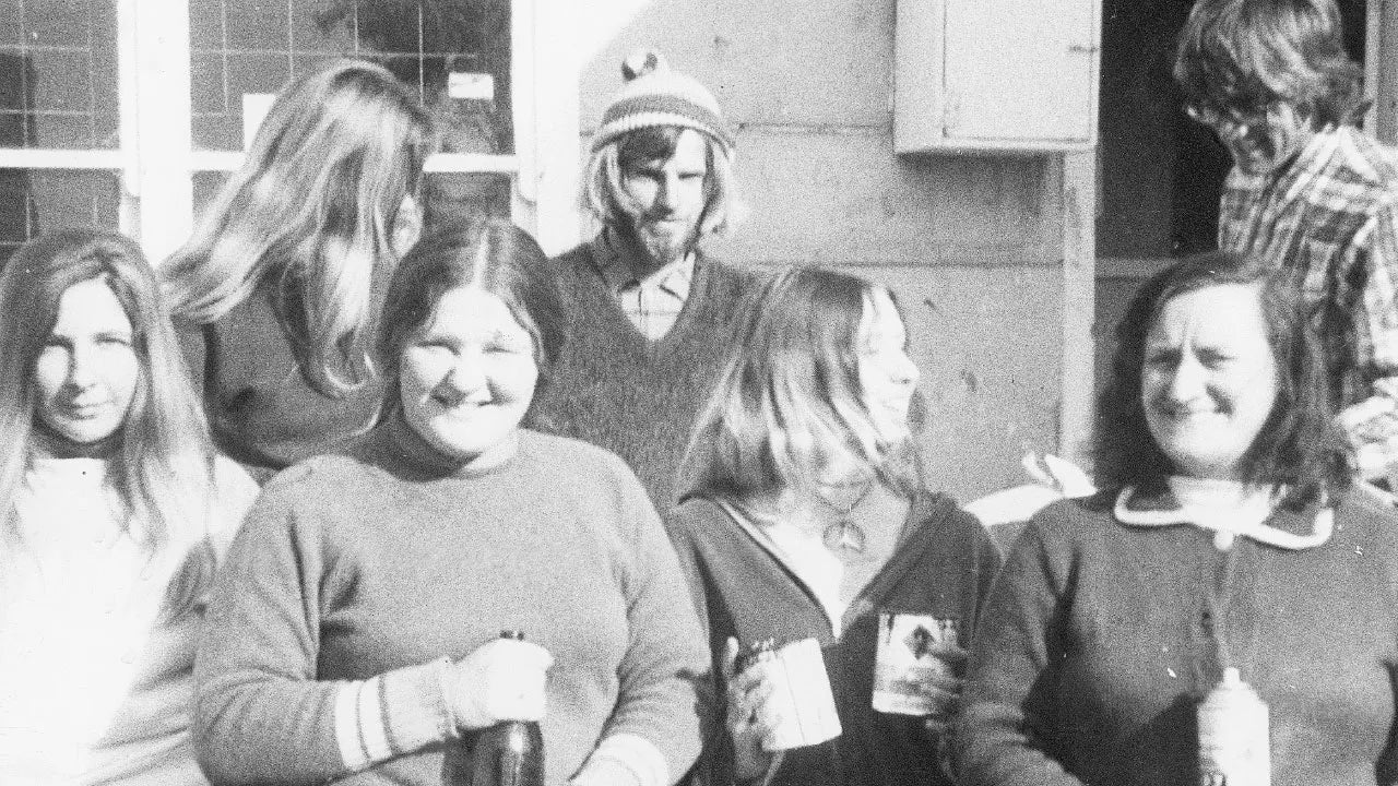Black and white photo of a group of people standing together outdoors.