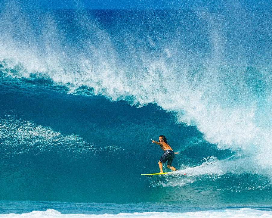 Surfer riding a large wave in the ocean