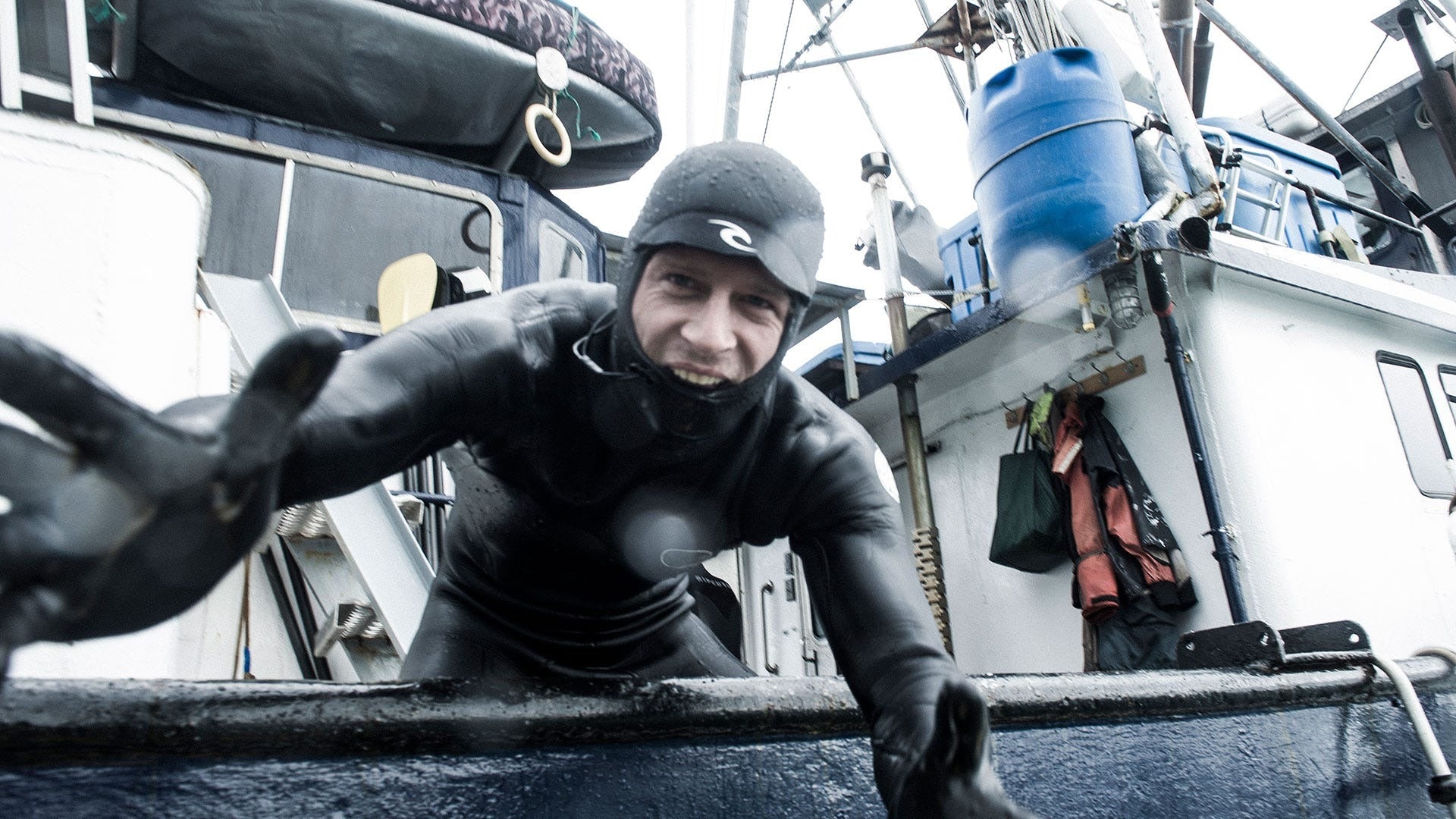 Person in diving gear on a boat deck