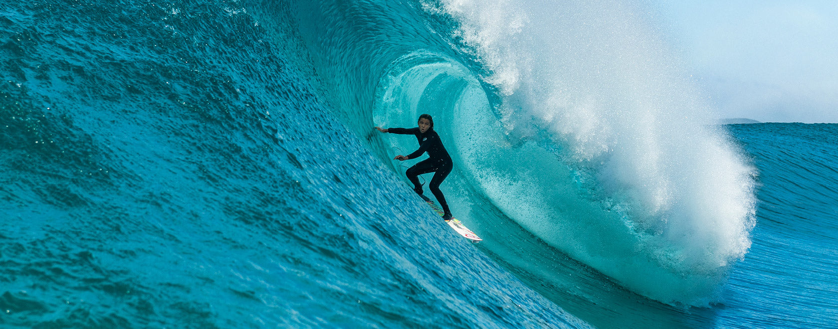 Surfer riding a large wave in the ocean