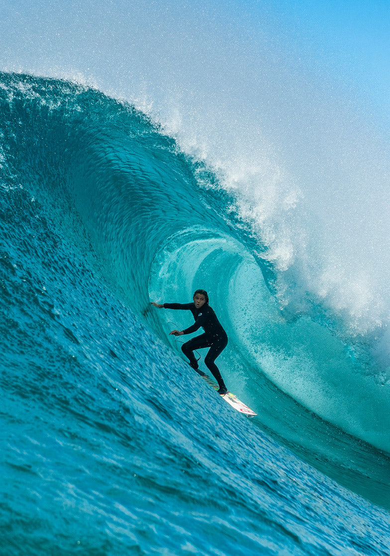 Surfer riding a large wave in the ocean