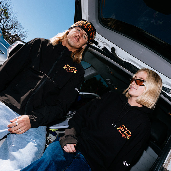 Two people sitting inside a vehicle with a clear sky background