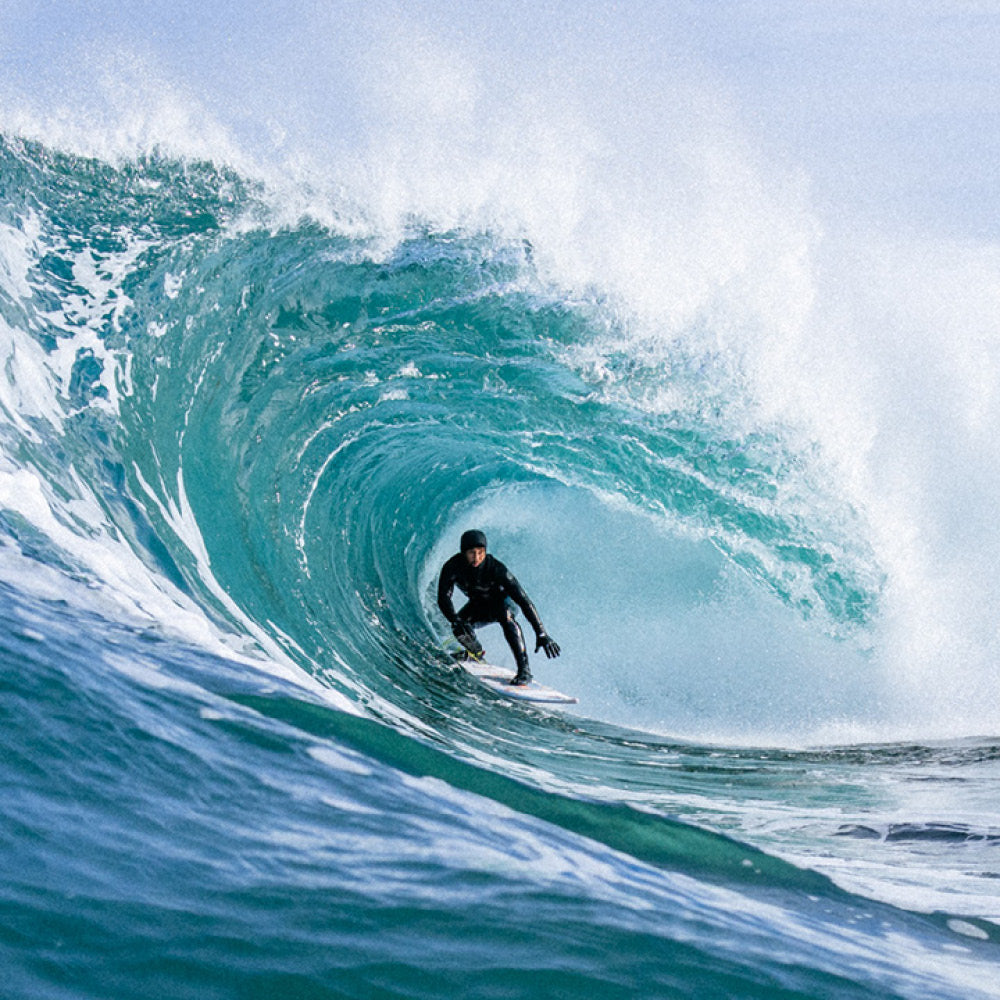 Surfer riding a large wave in the ocean