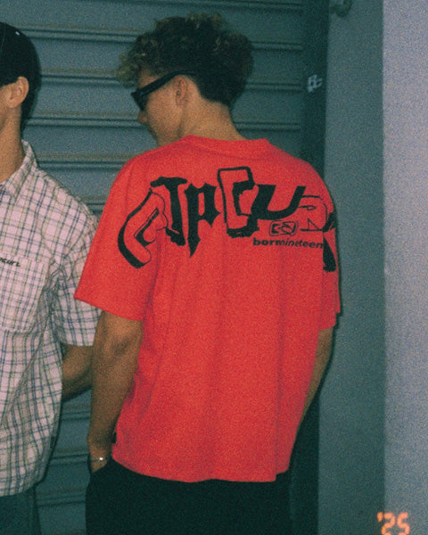 Model wears red Archive t-shirt
